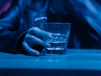 Close up of a person drinking water after session.